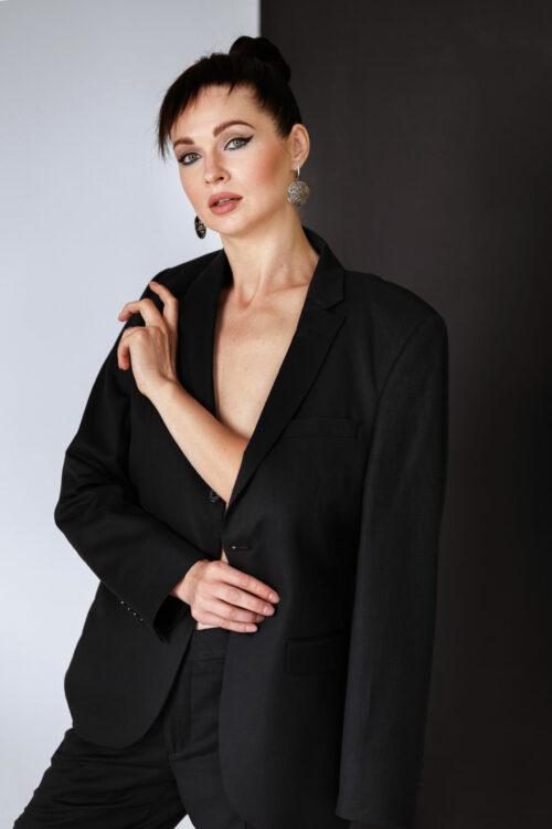 woman 30-40 years old in a man's jacket in the studio